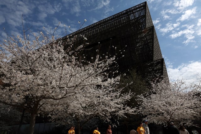 People walk past the Smithsonian’s National Museum of African American History and Culture in Washington, D.C., U.S., March 28, 2025. REUTERS/Leah Millis