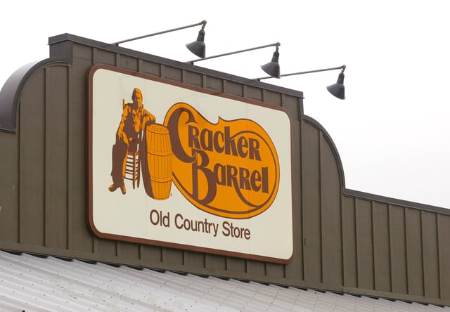 A Cracker Barrel Old Country Store sign is visible atop one of its restaurant stores April 12, 2002 in Naperville, IL.
