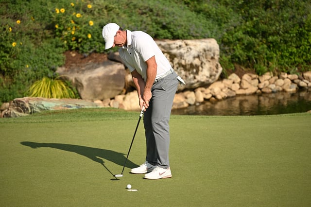 Aug 16, 2025; Owings Mills, Maryland, USA; Rory McIlroy sinks a putt on the 18th hole during the third round of the BMW Championship golf tournament. Mandatory Credit: Rafael Suanes-Imagn Images/ File Photo