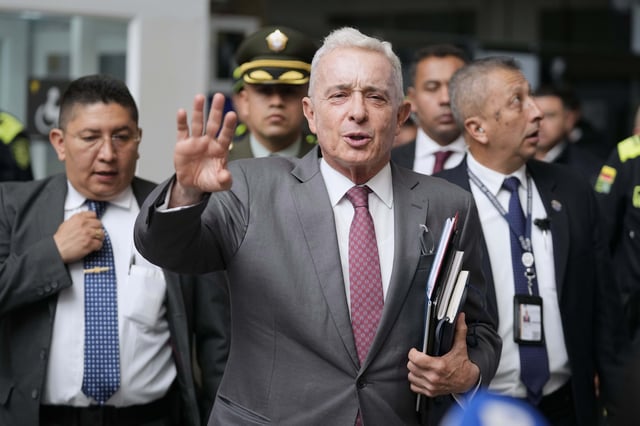 FILE - Former President Alvaro Uribe leaves court after a hearing in his trial over witness tampering and bribery charges in Bogota, Colombia, Feb. 10, 2025. (AP Photo/Fernando Vergara, File)