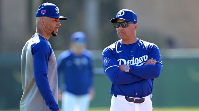 Feb 18, 2024; Glendale, AZ, USA; Los Angeles Dodgers second baseman Mookie Betts (50) talks with manager Dave Roberts (30) during spring training at Camelback Ranch. Mandatory Credit: Jayne Kamin-Oncea-Imagn Images