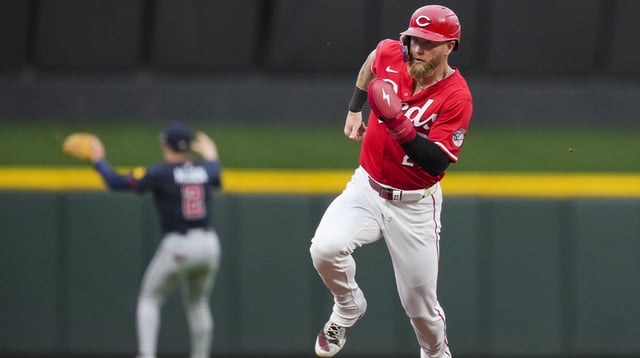 Jul 31, 2025; Cincinnati, OH, USA; Cincinnati Reds outfielder Jake Fraley (27) scores a run on a double hit by catcher Tyler Stephenson in the game against the Atlanta Braves in the second inning at Great American Ball Park. Mandatory Credit: Aaron Doster-Imagn Images