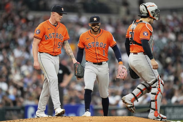 Houston Astros starting pitcher Hunter Brown, left, meets with third baseman Carlos Correa, center, and catcher Yainier Diaz for a mound visit during the third inning of a baseball game, Tuesday, Aug. 19, 2025, in Detroit. (AP Photo/Ryan Sun)