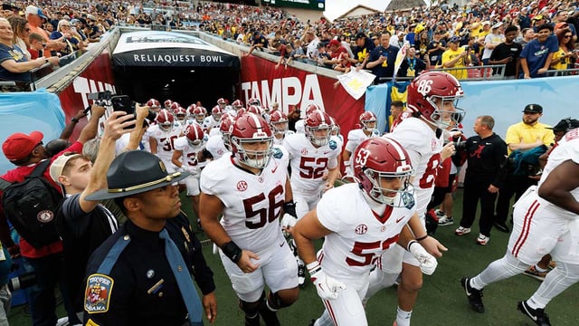 Dec 31, 2024; Tampa, FL, USA; Alabama Crimson Tide linebacker Vito Perri (53) and Alabama Crimson Tide punter James Burnip (86) lead the team onto the field before a game against the Michigan Wolverines at Raymond James Stadium. Mandatory Credit: Matt Pendleton-Imagn Images