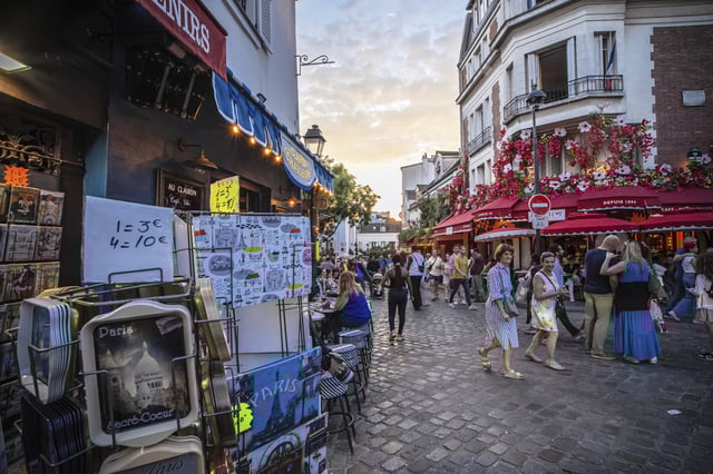 Tourists stroll in the Montmartre district in Paris, France, Monday, Aug. 4, 2025. (AP Photo/Aurelien Morissard)