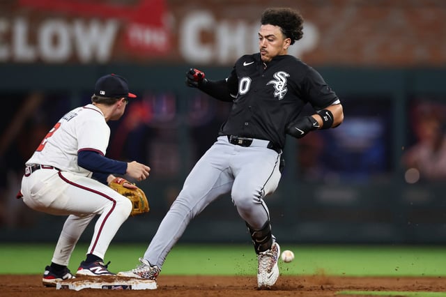 Chicago White Sox's Miguel Vargas, right, touches second base after hitting a double in the sixth inning of a baseball game against the Atlanta Braves, Tuesday, Aug. 19, 2025, in Atlanta. (AP Photo/Colin Hubbard)
