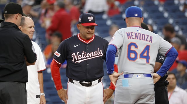 Aug 19, 2025; Washington, District of Columbia, USA; Washington Nationals interim manager Miguel Cairo (22) and New York Mets manager Carlos Mendoza (64) meet at home plate prior to their game at Nationals Park. Mandatory Credit: Amber Searls-Imagn Images