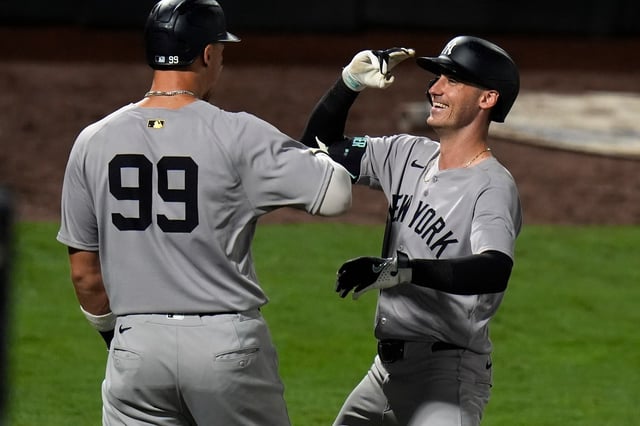 New York Yankees' Cody Bellinger celebrates his home run off Tampa Bay Rays pitcher Ian Seymour with Aaron Judge (99) during the sixth inning of a baseball game Tuesday, Aug. 19, 2025, in Tampa, Fla. (AP Photo/Chris O'Meara)
