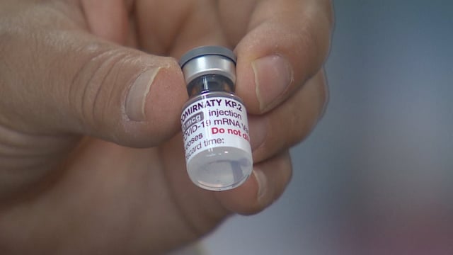 Edmonton pharmacist Mohamed Elfishawi holds up a vial of COVID-19 vaccine.
