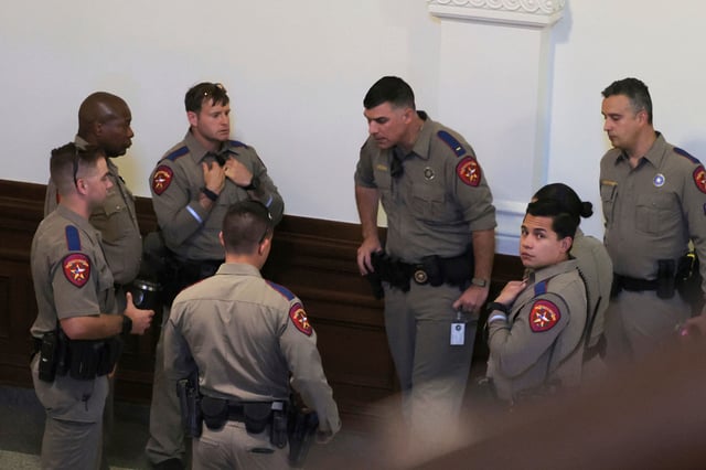 Texas state troopers gather at the Texas Capitol in Austin, Texas, Monday, Aug. 18, 2025. (AP Photo/Stephen Spillman)