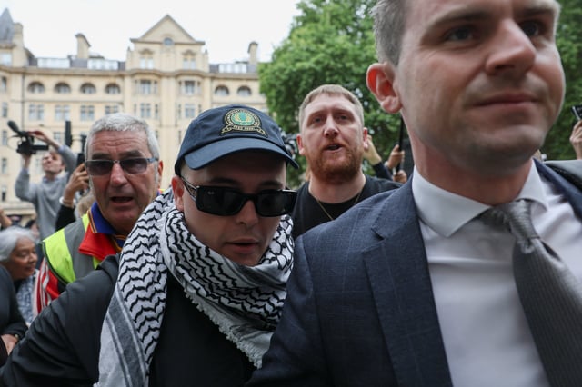 Member of Kneecap Liam O'Hanna, also known as Liam Og O hAnnaidh and performing under the name of Mo Chara, who has been charged with a terrorism offence in relation to the alleged display of a Hezbollah flag onstage in 2024, arrives at the Westminster Magistrates' Court, in London, Britain, August 20, 2025. REUTERS/Hannah McKay