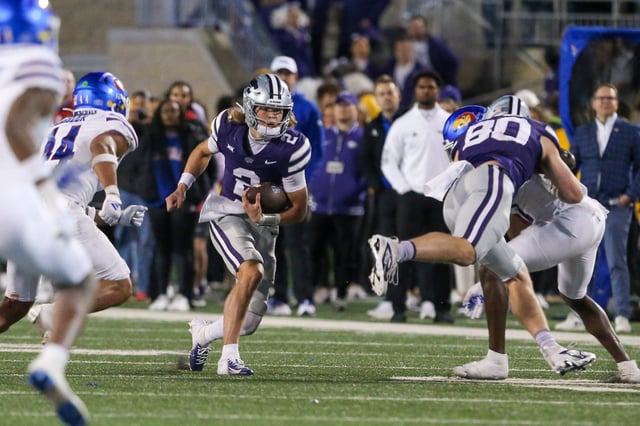 Oct 26, 2024; Manhattan, Kansas, USA; Kansas State Wildcats quarterback Avery Johnson (2) looks for room to run against the Kansas Jayhawks in the fourth quarter at Bill Snyder Family Football Stadium. Mandatory Credit: Scott Sewell-Imagn Images