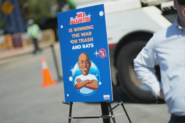 A sign at a Mayor Adams press conference highlights the city’s campaign against trash and rats.