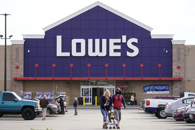 FILE - Shoppers walk in the lot of a Lowe's home improvement store in Philadelphia, Wednesday, Nov. 17, 2021. (AP Photo/Matt Rourke, File)
