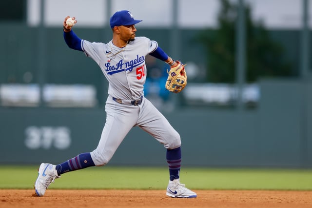 DENVER, CO - AUGUST 18: Mookie Betts #50 of the Los Angeles Dodgers throws to first for an out in the third inning against the Colorado Rockies at Coors Field on August 18, 2025 in Denver, Colorado.