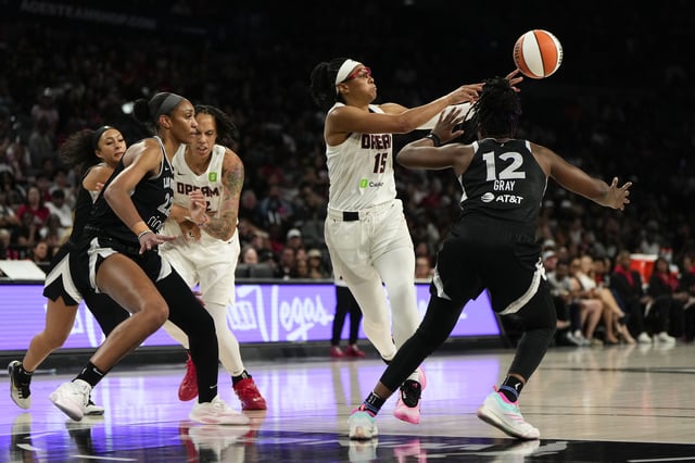 Aug 19, 2025; Las Vegas, Nevada, USA; Atlanta Dream guard Allisha Gray (15) passes the ball against Las Vegas Aces guard Chelsea Gray (12) and center A'ja Wilson (22) during the second half of a WNBA basketball game at Michelob Ultra Arena. Mandatory Credit: Lucas Peltier-Imagn Images
