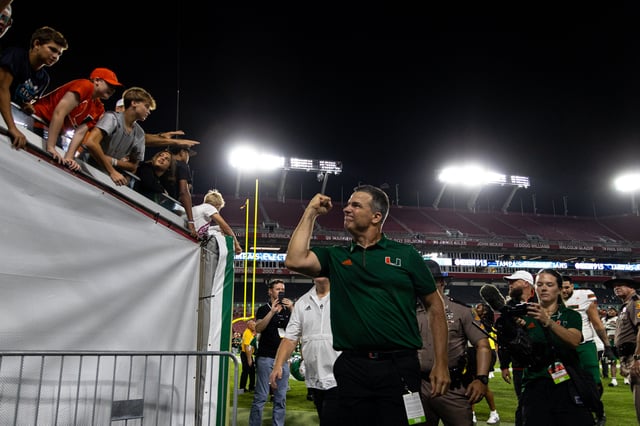 Head coach Mario Cristobal celebrates while walking into the tunnel after Miami's win over USF at Raymond James Stadium on Sept. 21, 2024. Photo Credit: Jason Hill - Co-Photo Editor