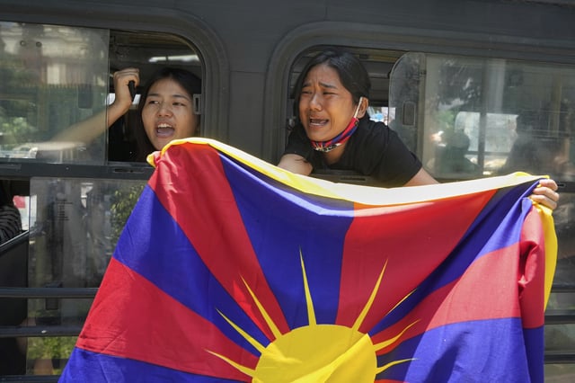 Exiled Tibetans shout slogans from a bus after being detained and taken to a police station during a protest against the visit of Chinese Foreign Minister Wang Yi to India, in New Delhi, India, on Tuesday, Aug. 19, 2025. (AP Photo/Manish Swarup)