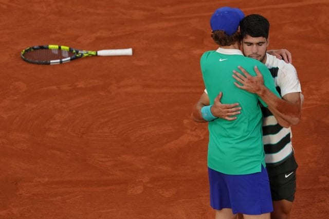 Spain’s Carlos Alcaraz hugs Italy’s Jannik Sinner after winning the final match of the French Tennis Open at the Roland-Garros in Paris, Sunday, June 8, 2025. (AP Photo/Aurelien Morissard)