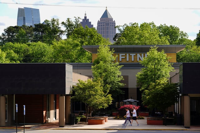 People walk past an LA Fitness gym in Atlanta, Georgia, U.S., April 21, 2020. REUTERS/Elijah Nouvelage/File Photo