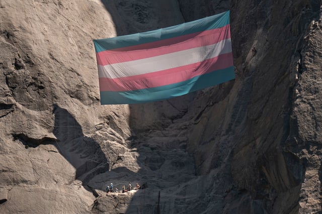 A group of people, including Shannon Joslin, a Yosemite National Park ranger and biologist who was fired, hang a transgender flag on El Capitan in Yosemite National Park, Calif., May 20, 2025.