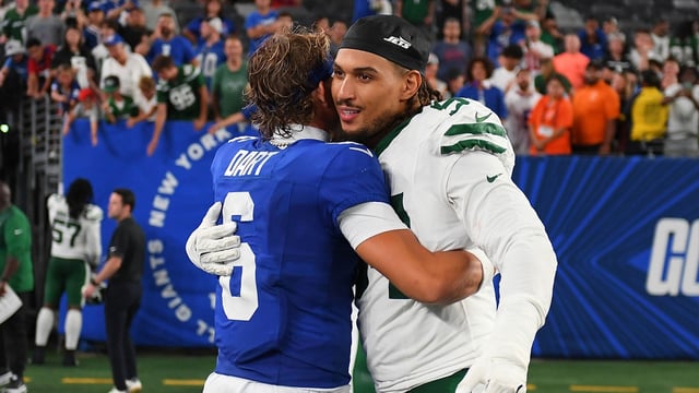 Aug 16, 2025; East Rutherford, New Jersey, USA; New York Giants quarterback Jaxson Dart (left) greets New York Jets defensive end Tyler Baron (right) following the game at MetLife Stadium. Mandatory Credit: Rich Barnes-Imagn Images