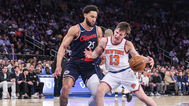 Mar 26, 2025; New York, New York, USA; New York Knicks guard Tyler Kolek (13) looks to drive past LA Clippers guard Ben Simmons (25) in the third quarter at Madison Square Garden. Mandatory Credit: Wendell Cruz-Imagn Images