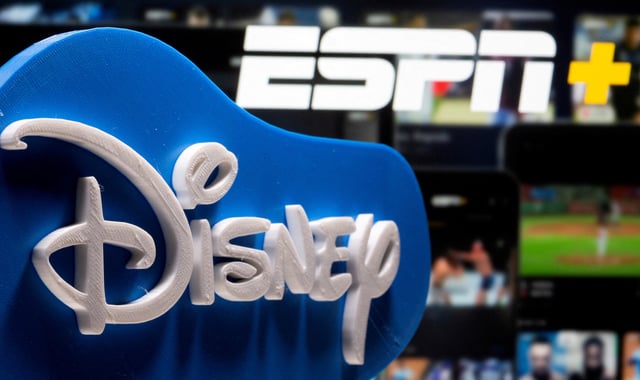 A 3D printed Disney logo is seen in front of the ESPN+ logo in this illustration created on July 13, 2021. REUTERS/Dado Ruvic/Illustration/File Photo