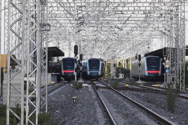 A Maya Train car, center, sits derailed at a station in Izamal, Yucatan state, Mexico, Tuesday, Aug. 19, 2025. (AP Photo/Martin Zetina)