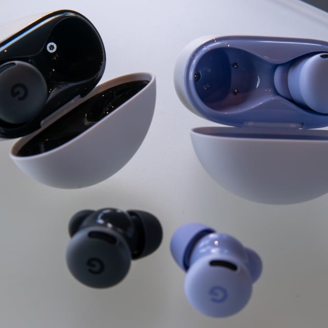 Pixel Buds 2a earbuds in Hazel and Iris next to their cases