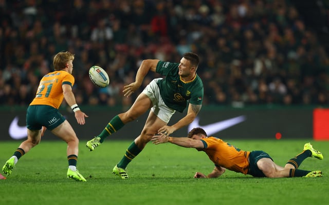 Rugby Union - Rugby Championship - South Africa v Australia - Ellis Park, Johannesburg, South Africa - August 16, 2025 South Africa's Damian Willemse in action with Australia's Tate McDermott and Andrew Kellaway REUTERS/Siphiwe Sibeko/File Photo
