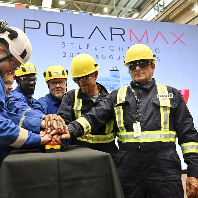 Davie's and Helsinki Shipyard's personnel press the button together during a steel cutting ceremony for the beginning of construction of the PolarMax Icebreaker, at Helsinki Shipyard in Helsinki, Finland on August 20, 2025. PolarMax is the first newbuild project at the Helsinki Shipyard under Canadian-owned Davie's ownership.