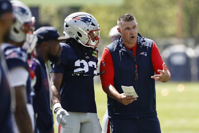 FOXBOROUGH, MA - JULY 28: Mike Vrabel head coach of the New England Patriots talks with Kyle Dugger #23 during training camp at Gillette Stadium on July 28, 2025 in Foxborough, Massachusetts.
