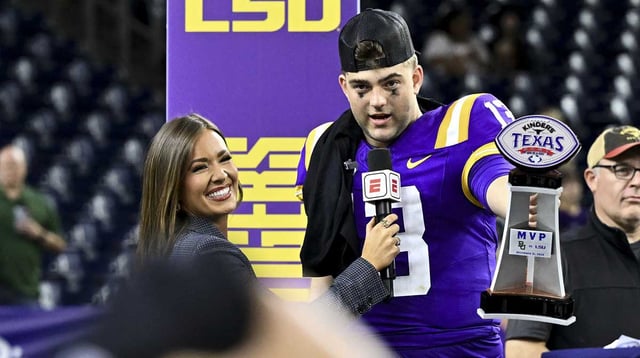 Dec 31, 2024; Houston, TX, USA; LSU Tigers quarterback Garrett Nussmeier (13) holds up the MVP trophy during a post game interview of the game against the Baylor Bears at NRG Stadium. The Tigers defeat the Bears 44-31. Mandatory Credit: Maria Lysaker-Imagn Images