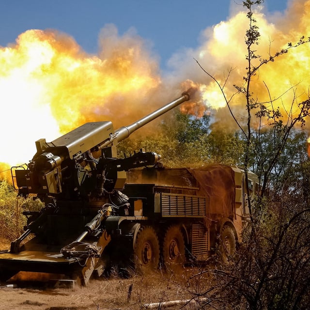 A Ukrainian serviceman fires a self-propelled howitzer towards Russian troops near a front line.