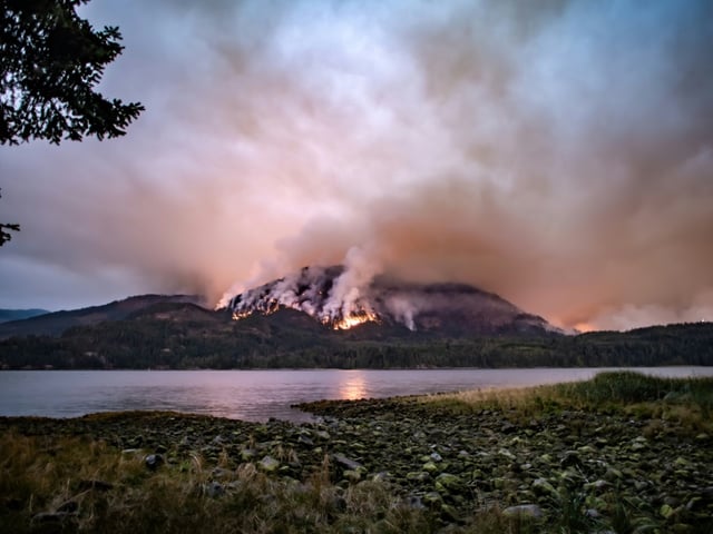 A wildfire burns on Mount Underwood near Port Alberni, Canada, on August 12, 2025