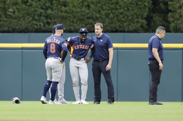 Aug 20, 2025; Detroit, Michigan, USA;  Houston Astros outfielder Taylor Trammell (center) is checked on after he is injured in the first inning against the Detroit Tigers at Comerica Park. Mandatory Credit: Rick Osentoski-Imagn Images