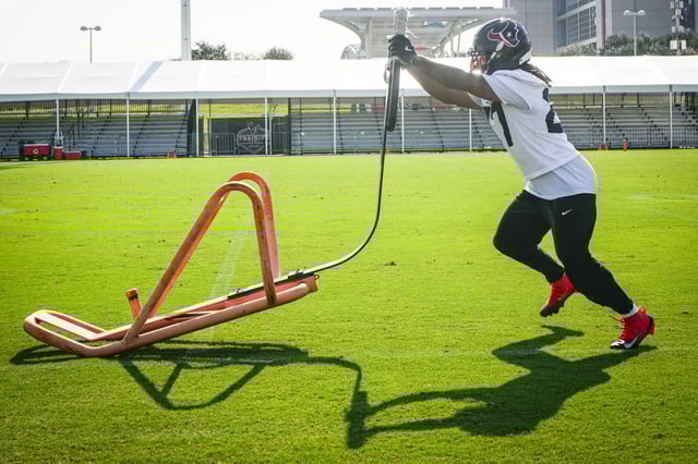 Houston Texans cornerback Myles Bryant  hits a blocking sled during an NFL training camp practice at Houston Methodist Training Center in Houston, Wednesday, Aug. 20, 2025.