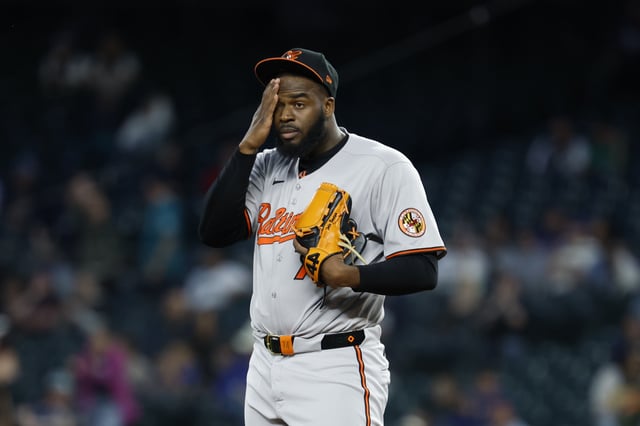 SEATTLE, WASHINGTON - JUNE 04: Felix Bautista #74 of the Baltimore Orioles wipes hit forehead during the game against the Seattle Mariners at T-Mobile Park on June 04, 2025 in Seattle, Washington. The Baltimore Orioles won 3-2.