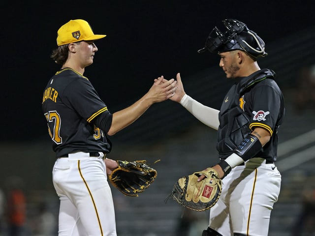 BRADENTON, FLORIDA - MARCH 14: Bubba Chandler #57 of the Pittsburgh Pirates is congratulated by teammate Omar Alfonzo #50 after defeating the Baltimore Orioles 3-1 during a spring training game at LECOM Park on March 14, 2024 in Bradenton, Florida.