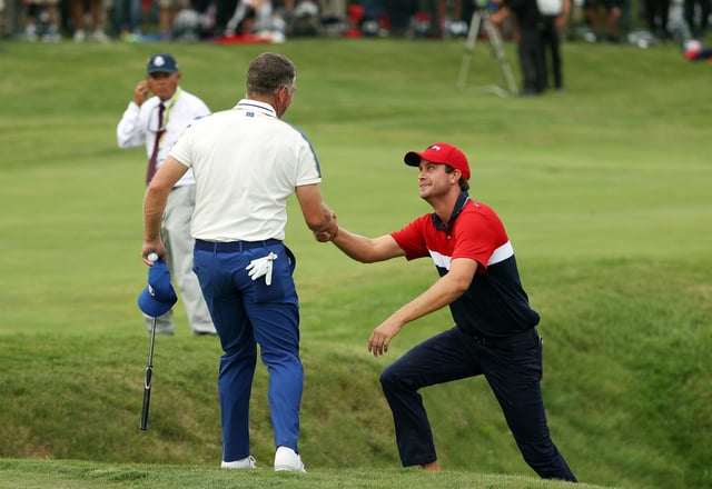 KOHLER, WISCONSIN - SEPTEMBER 26: Lee Westwood of England and team Europe helps Harris English of team United States up an incline on the 18th hole during Sunday Singles Matches of the 43rd Ryder Cup at Whistling Straits on September 26, 2021 in Kohler, Wisconsin. (Photo by Patrick Smith/Getty Images)