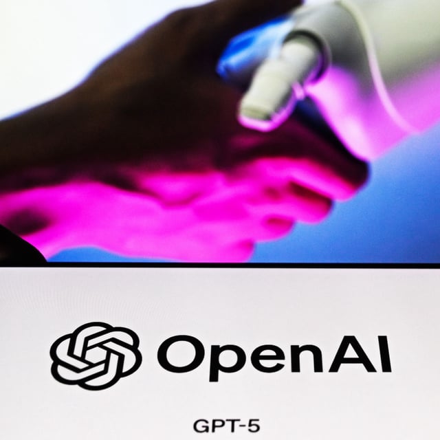 ANKARA, TURKIYE - AUGUST 13: In this photo illustration, the logo of OpenAI logo is being displayed on a mobile phone screen in front of another screen displaying a robotic hand, in Ankara, Turkiye on August 13, 2025. (Photo by Ismail Aslandag/Anadolu via Getty Images)
