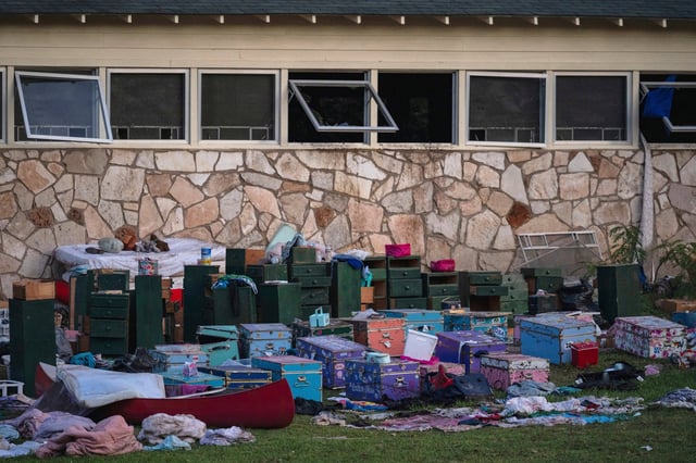 FILE - The belongings of campers sit outside one of Camp Mystic's cabins near the Guadalupe River in Hunt, Texas, on July 7, 2025, after a deadly flash flood swept through the area. (AP Photo/Eli Hartman, File)