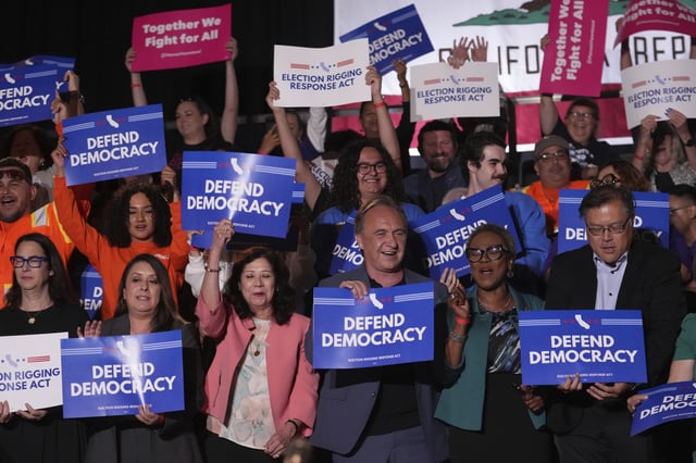 People await a news conference with California Gov. Gavin Newsom Thursday, Aug. 14, 2025, in Los Angeles.