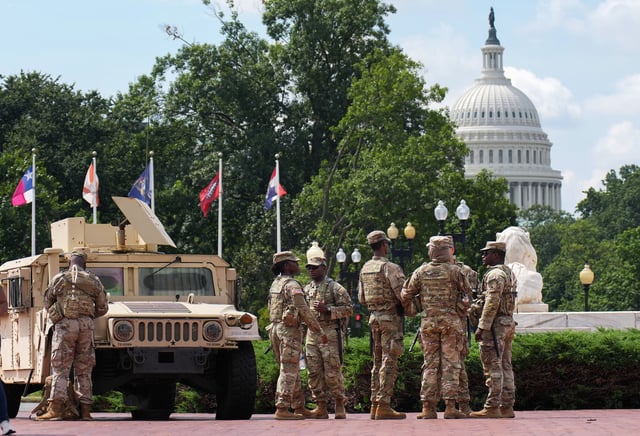 Members of the National Guard can be seen standing by at Union Station on August 14, 2025, in Washington, D.C. (Photo by Kevin Dietsch/Getty Images)