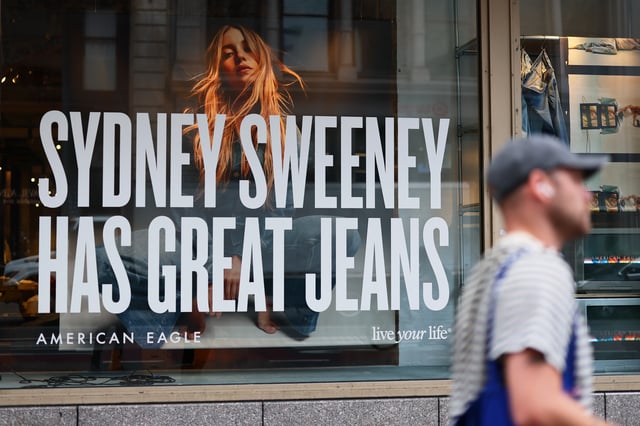 NEW YORK, NEW YORK - AUGUST 01: A window display of actress Sydney Sweeney is seen on a window of an American Eagle store on August 01, 2025 in New York City. American Eagle’s recent denim ad campaign featuring  Sweeney has drawn backlash for language and imagery that critics say echoes eugenics-era rhetoric, following a tagline referencing “great genes” alongside visuals of Sweeney in blue jeans. (Photo by Michael M. Santiago/Getty Images)