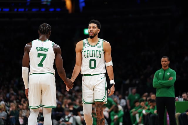 Jayson Tatum #0 of the Boston Celtics low-fives Jaylen Brown #7 of the Boston Celtics as he enters the court during the first quarter of the game against the Detroit Pistons at TD Garden on November 09, 2022 in Boston, Massachusetts.