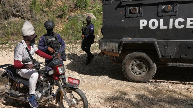 Police officers are seen patrolling in the Kenscoff neighbourhood, in Haiti's capital of Port-au-Prince, earlier this month. Haitian officials say two officers were killed in a mishap involving an explosive drone, at a base in Kenscoff on Tuesday evening.
