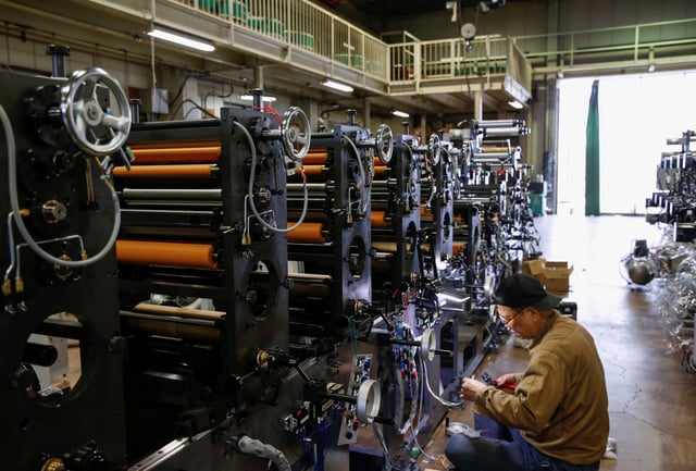A worker checks machinery at a factory in Higashiosaka, Japan June 23, 2022.  REUTERS/Sakura Murakami/File Photo