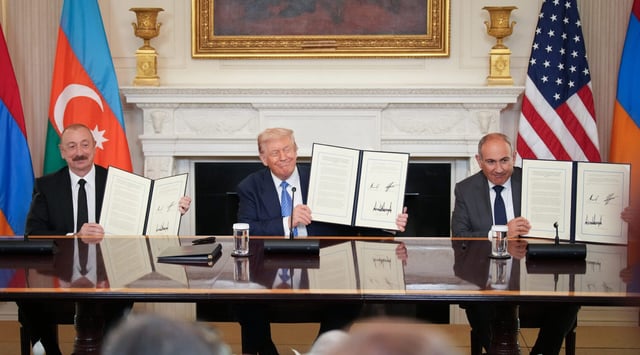 U.S. President Donald Trump, flanked by Azerbaijani President Ilham Aliyev (L) and Armenian Prime Minister Nikol Pashinyan (R) hold up an agreement signed during a ceremony in the State Dining Room of the White House on Aug. 8, 2025. (Andrew Harnik/Getty Images)
